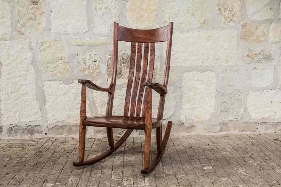 a comfortable rocking chair on bricks