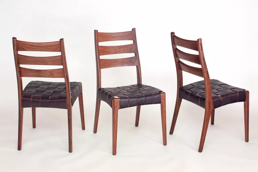 Three Webb Dining Chairs from a set in walnut.  All seats strapped.  Each angle different.