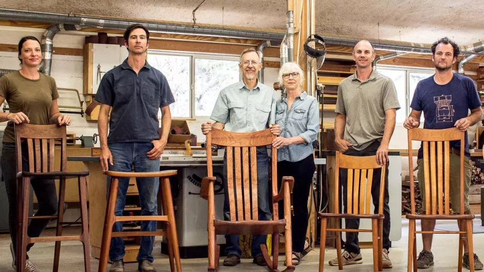the company standing behind the furniture