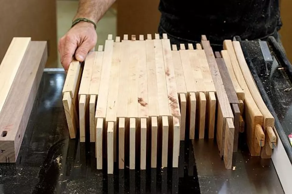 a row of rails with rough cut tenons