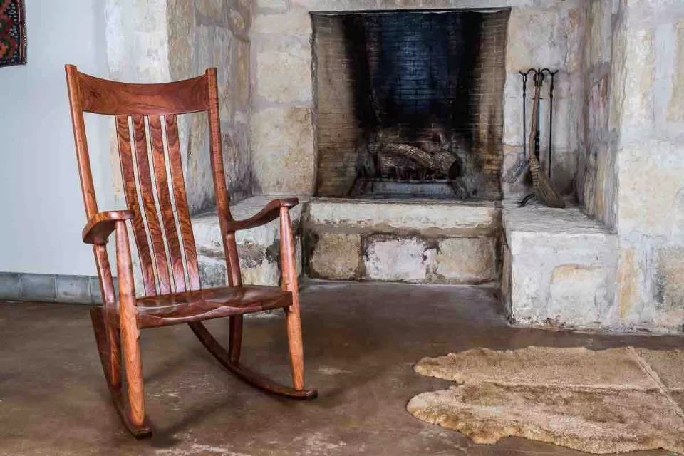 Rocking chair by fireplace
