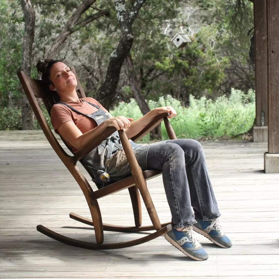 Woman in a rocking chair on a porch