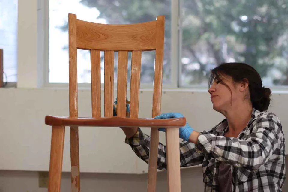 Audra oiling a cherry barstool