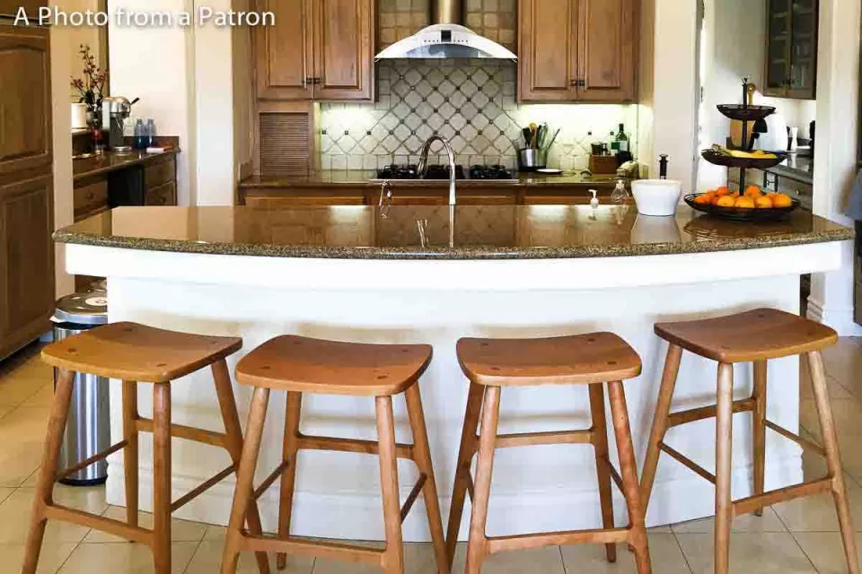 four Berry barstools at a curved counter
