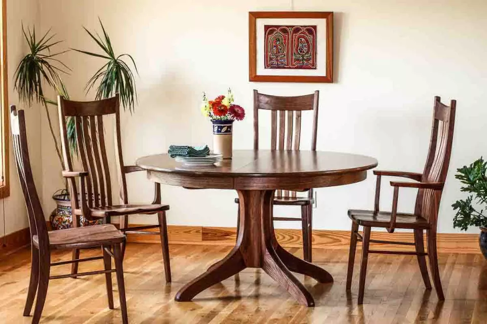 Johnson pedestal table with four chairs in setting