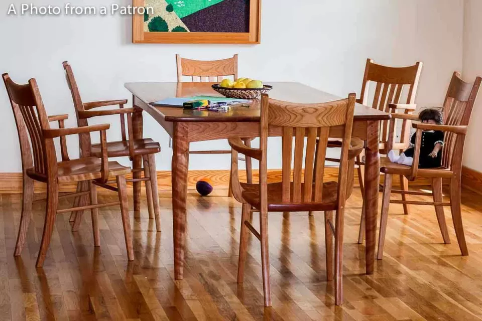 Paschall dining table and six Williams chairs in cherry in setting