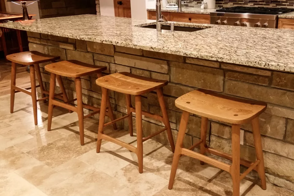 four Berry barstools at granite counter