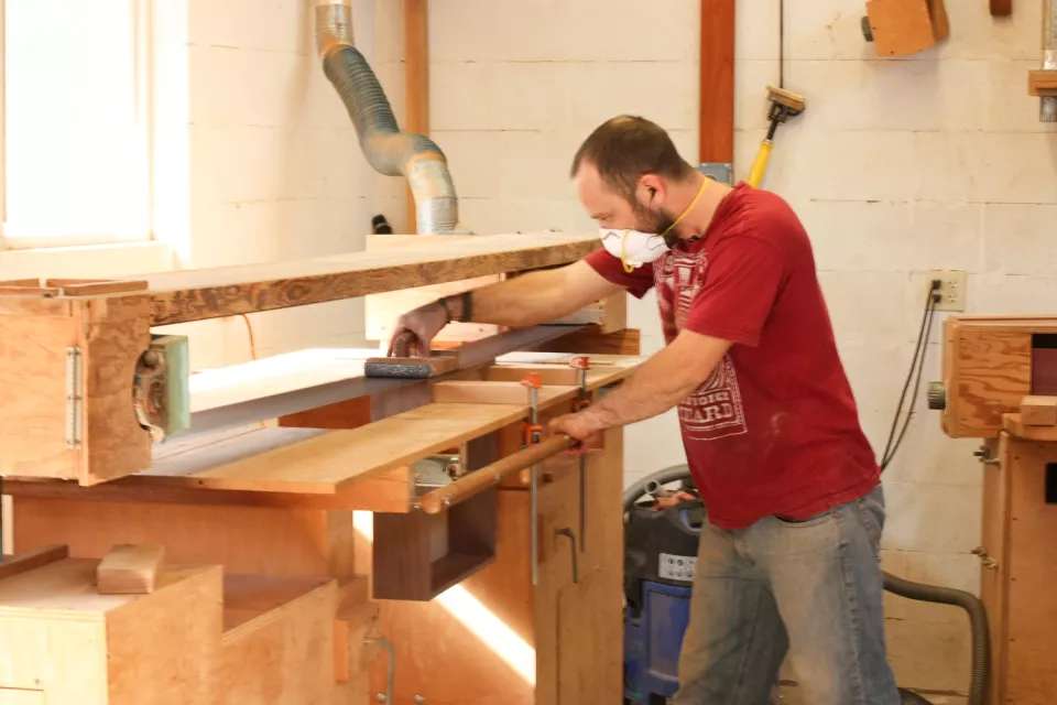 Aaron stroke sanding a drawer side to fit