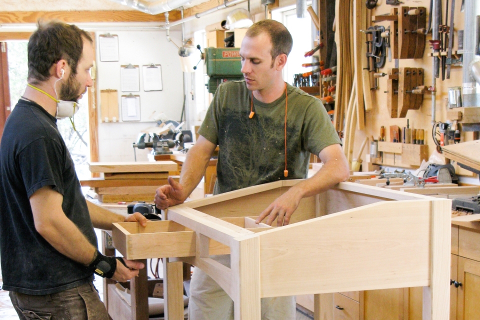 Austin and Aaron fitting standup desk drawers