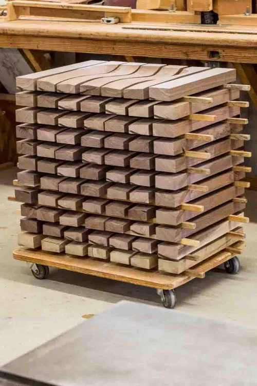 a stack of walnut rocking chair seats