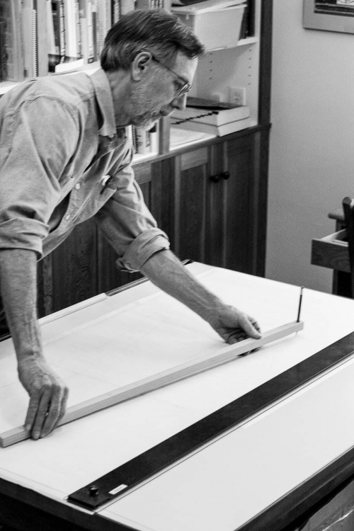 Gary scribing a large radius at the drawing board