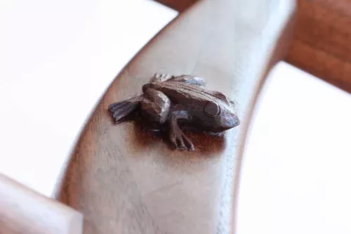 frog carved on rocking chair leg