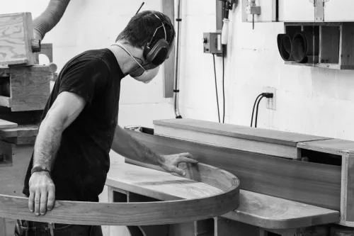Aaron sanding a curved apron at the edge sander