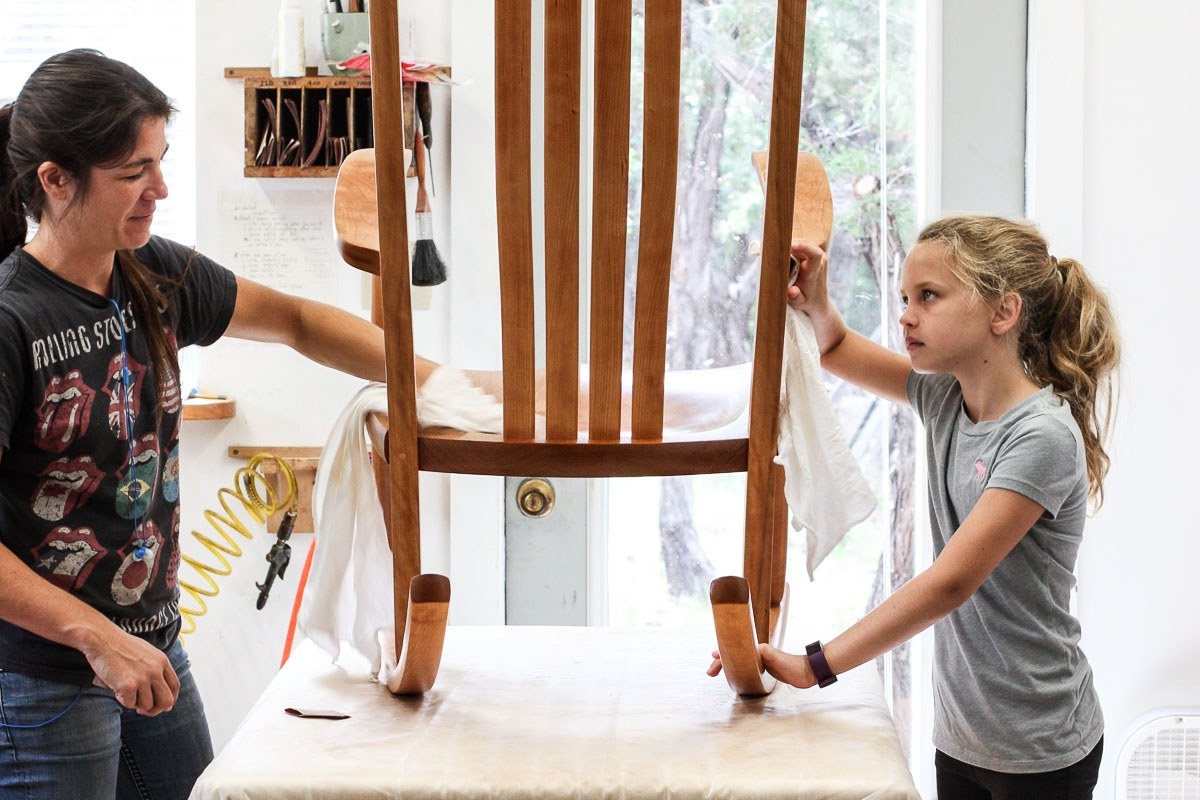 Audra and Wiley finishing a rocking chair