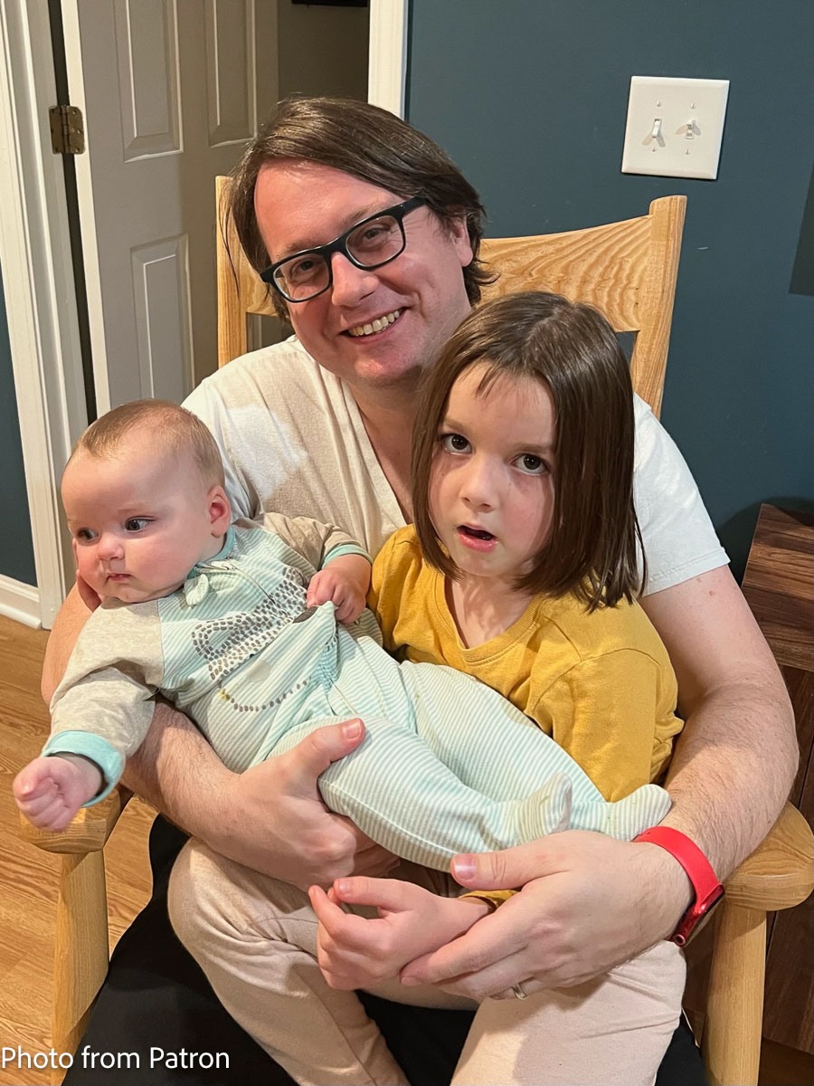 father, daughter, and baby in rocking chair