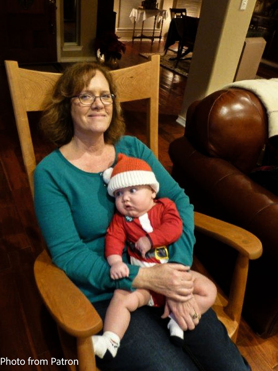 grandmother and grandchild in Santa suit in rocking chair