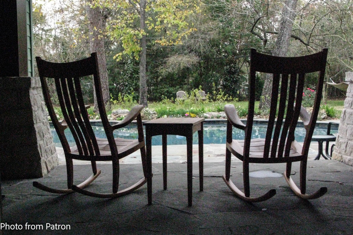 two mahogany porch rockers by a pool