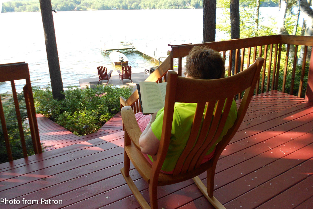 Reading in a Porch Rocker by a Lake