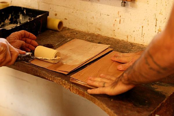 spreading glue on veneer